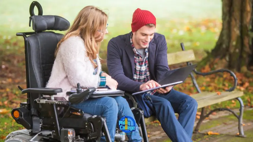 People in wheelchairs sitting on a park bench