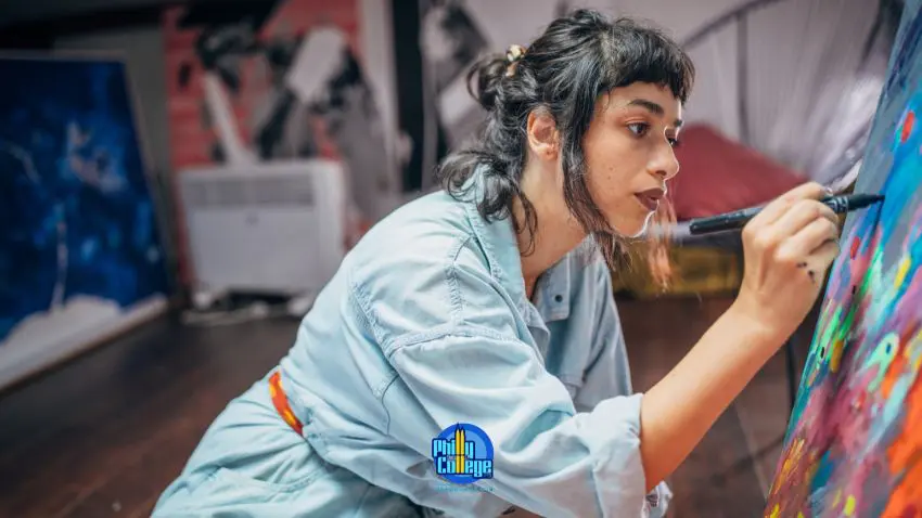 A woman is painting on a large canvas