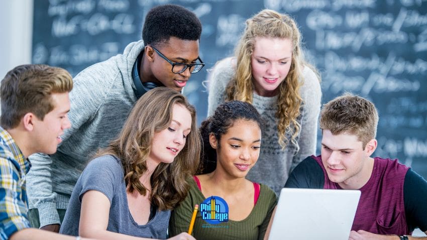 a group of people looking at a laptop
