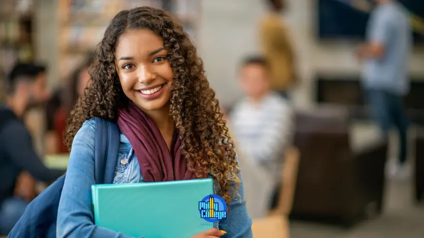 a smiling woman holding a folder in a library