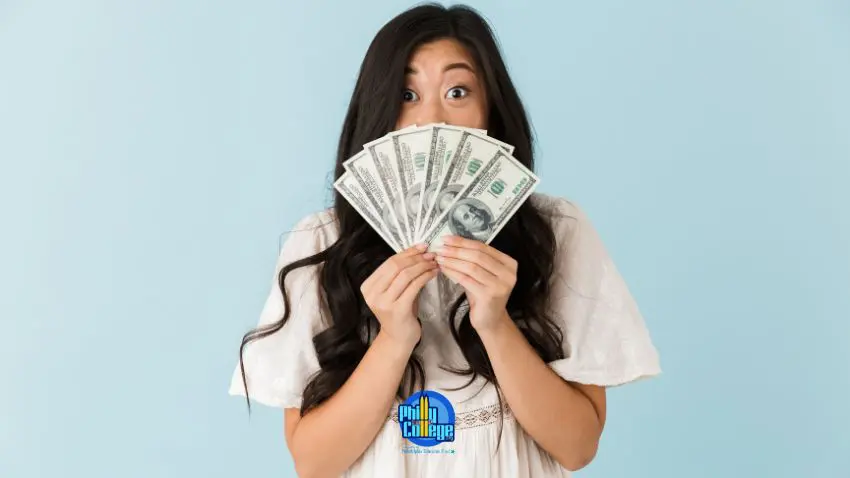 A person holding money in front of their face