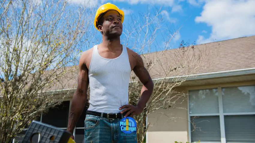 A person in a hard hat standing in front of a house