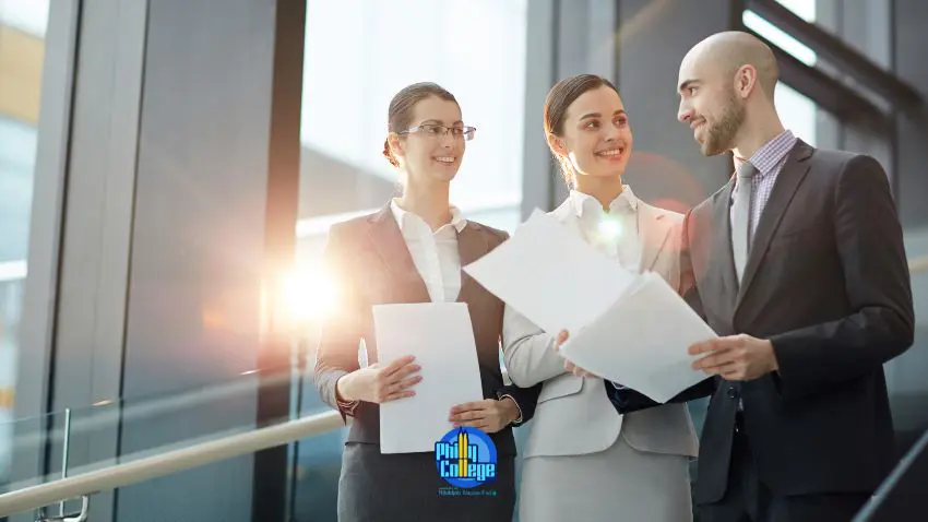 three business people standing in front of a large window