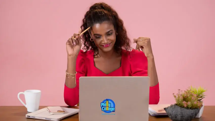 A person sitting at a desk with a laptop