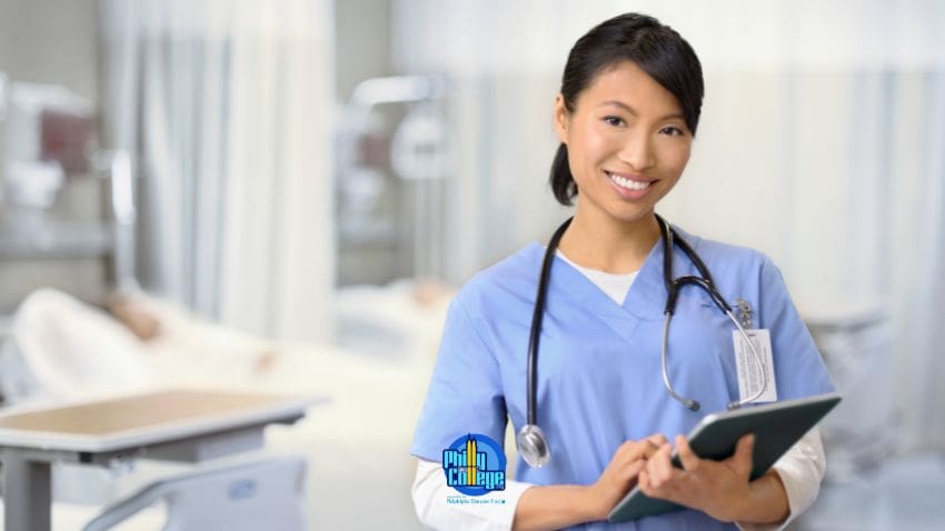 A nurse holding a tablet in a hospital room
