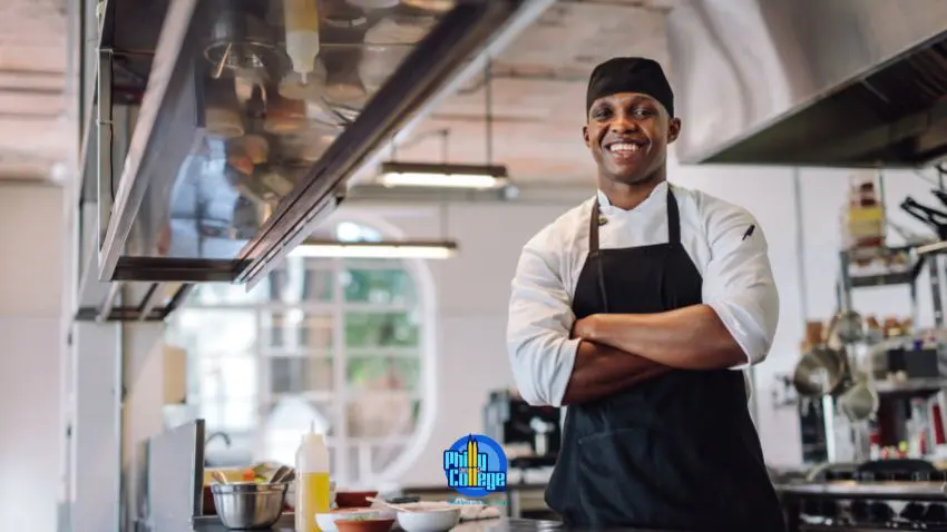 chef smiling at the camera in a commercial kitchen