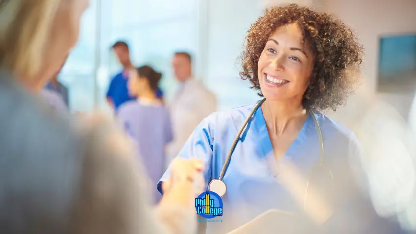 smiling doctor shaking hands with patient in hospital