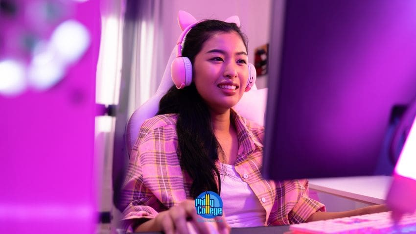 A person wearing headphones in front of a computer screen