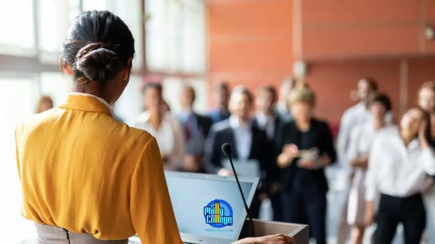 A person giving a presentation in front of a group of people
