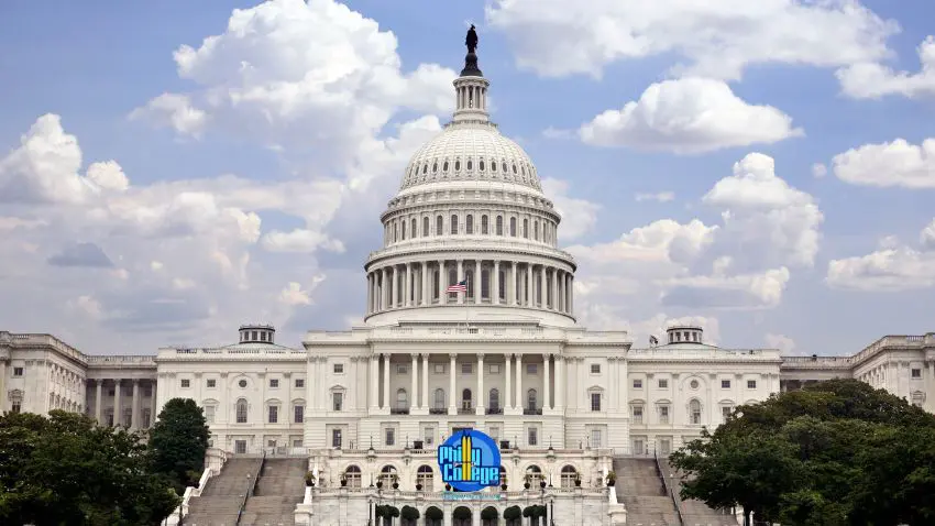 The United States Capitol Building with its dome and columns, set against a cloudy blue sky.
