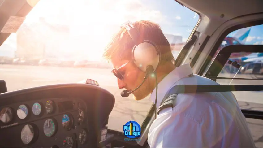 A person wearing headphones sits in the cockpit of a helicopter