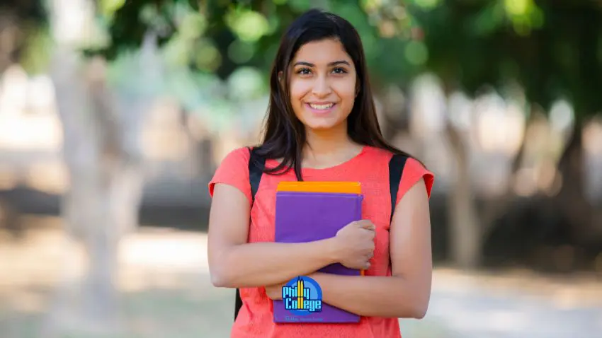 a smiling person holding a book in their hands