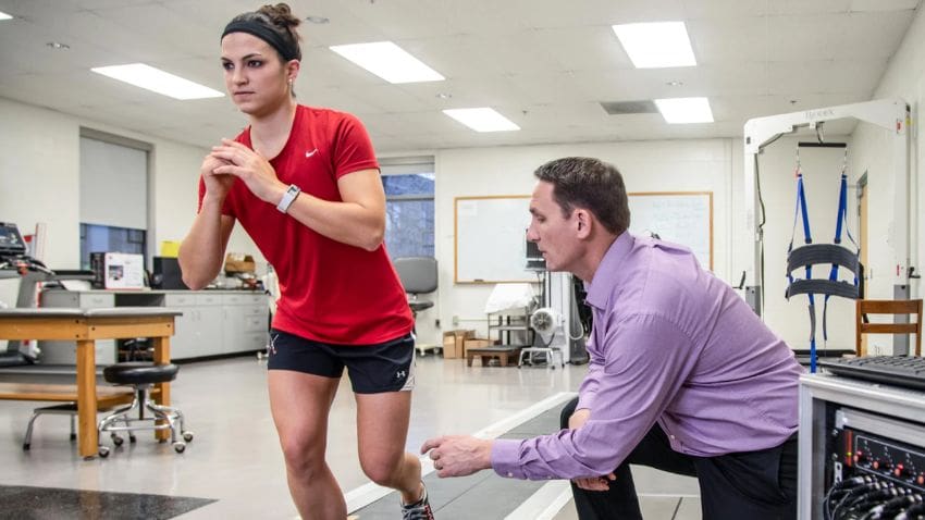 Athlete and PT doing exercises