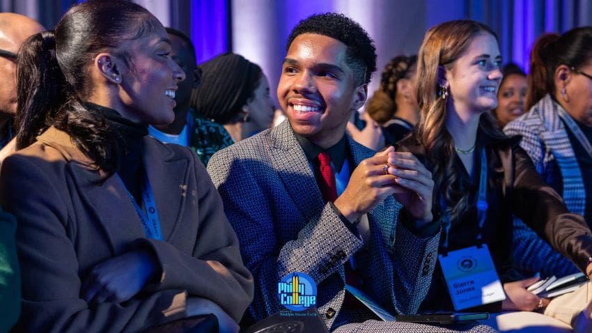 Young students at award ceremony smiling in the audience