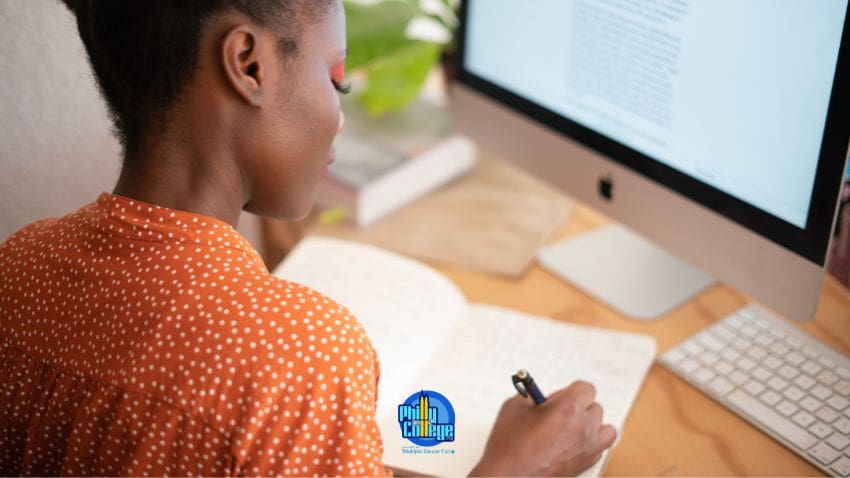 A person sitting at a desk in front of a computer.